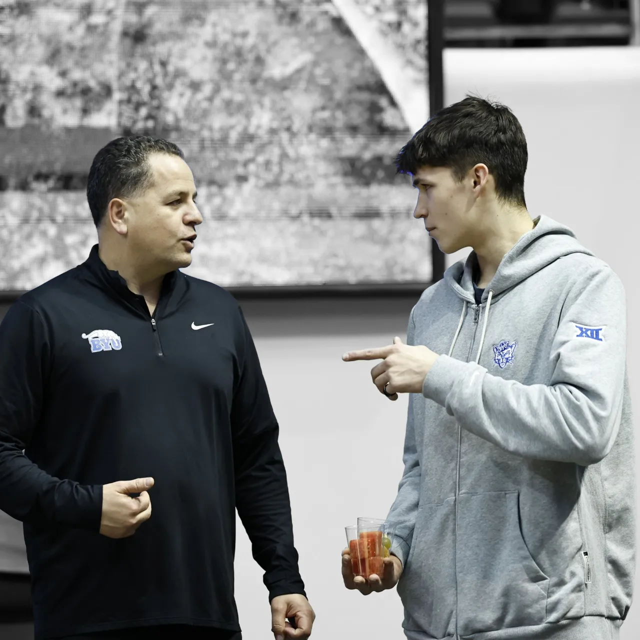 Egor Demin talking with Mike Davie courtside